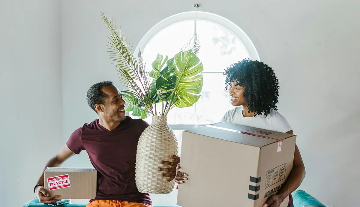 first-time apartment renters surrounded by moving boxes
